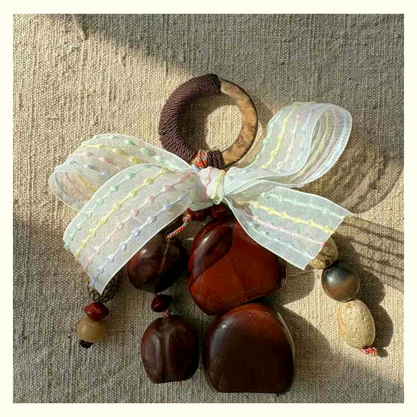 Bow Tie Natural Shell Rattle Charm - Brown