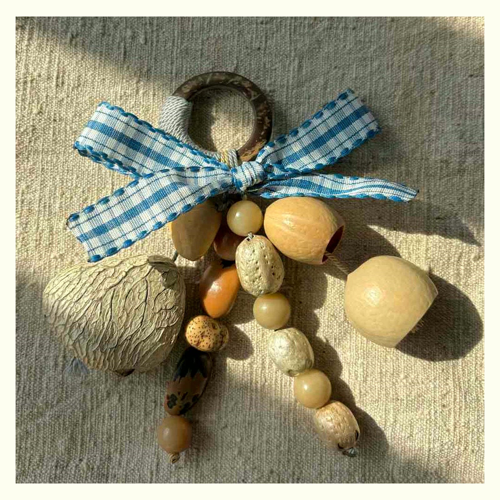 Bow Tie Natural Shell Rattle Charm - Blue