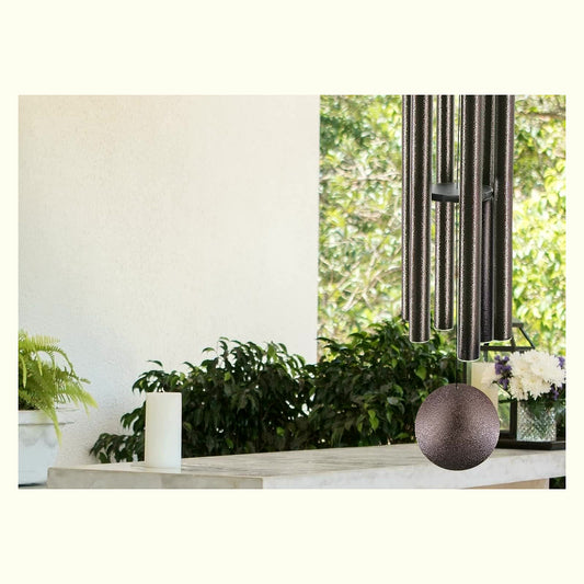 Forest Spirit Bamboo Wind Chime — cottagecore wind chime hanging on white wall with ferns and candle